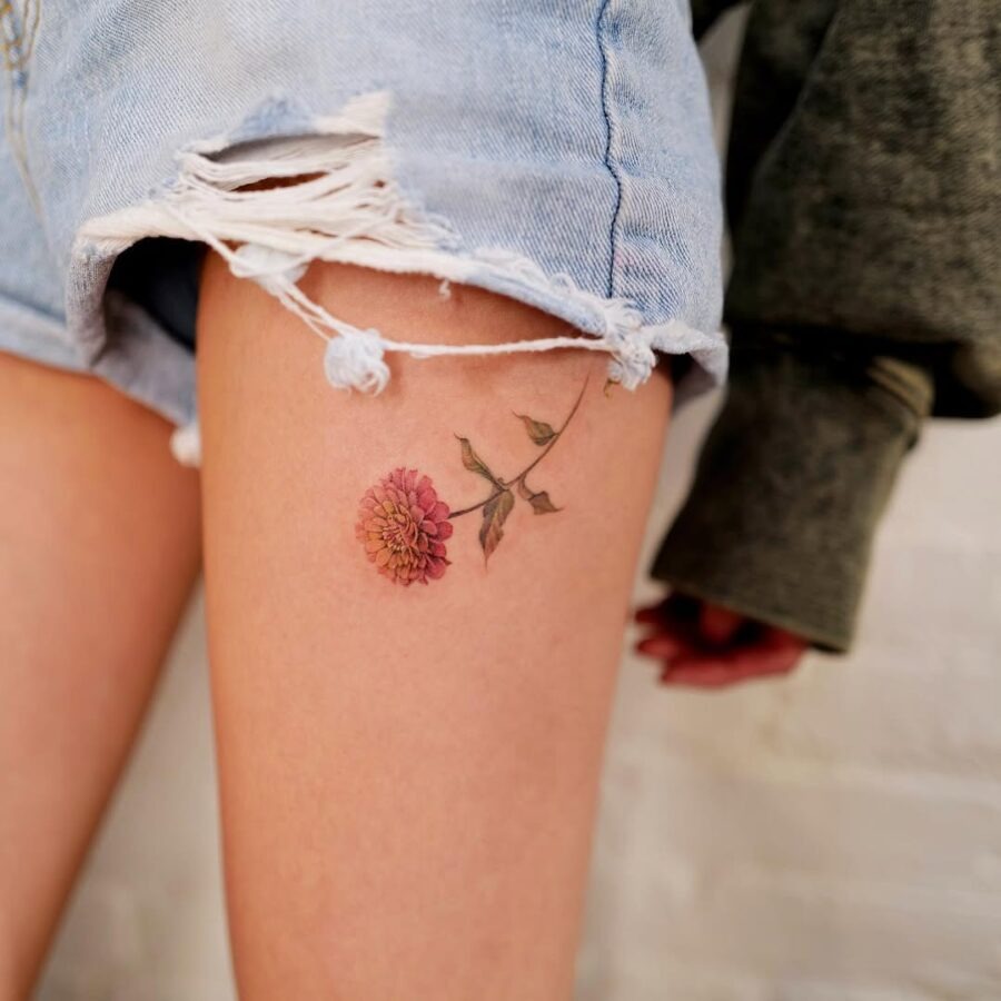 Beautiful zinnia flower tattoo on thigh Tattoo Design