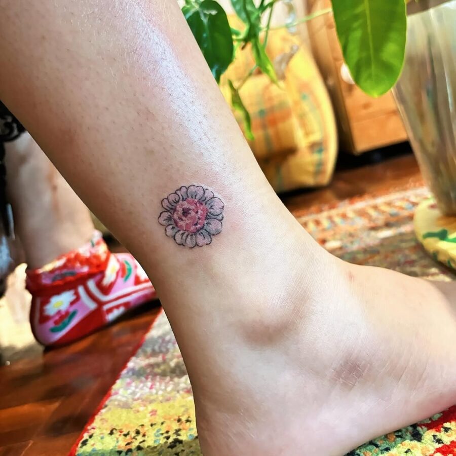 Charming zinnia tattoo on the ankle Tattoo Design