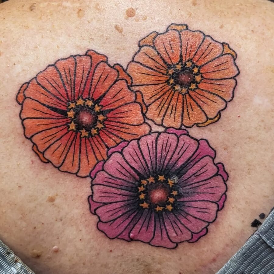 Colorful zinnia tattoos blooming on skin Tattoo Design