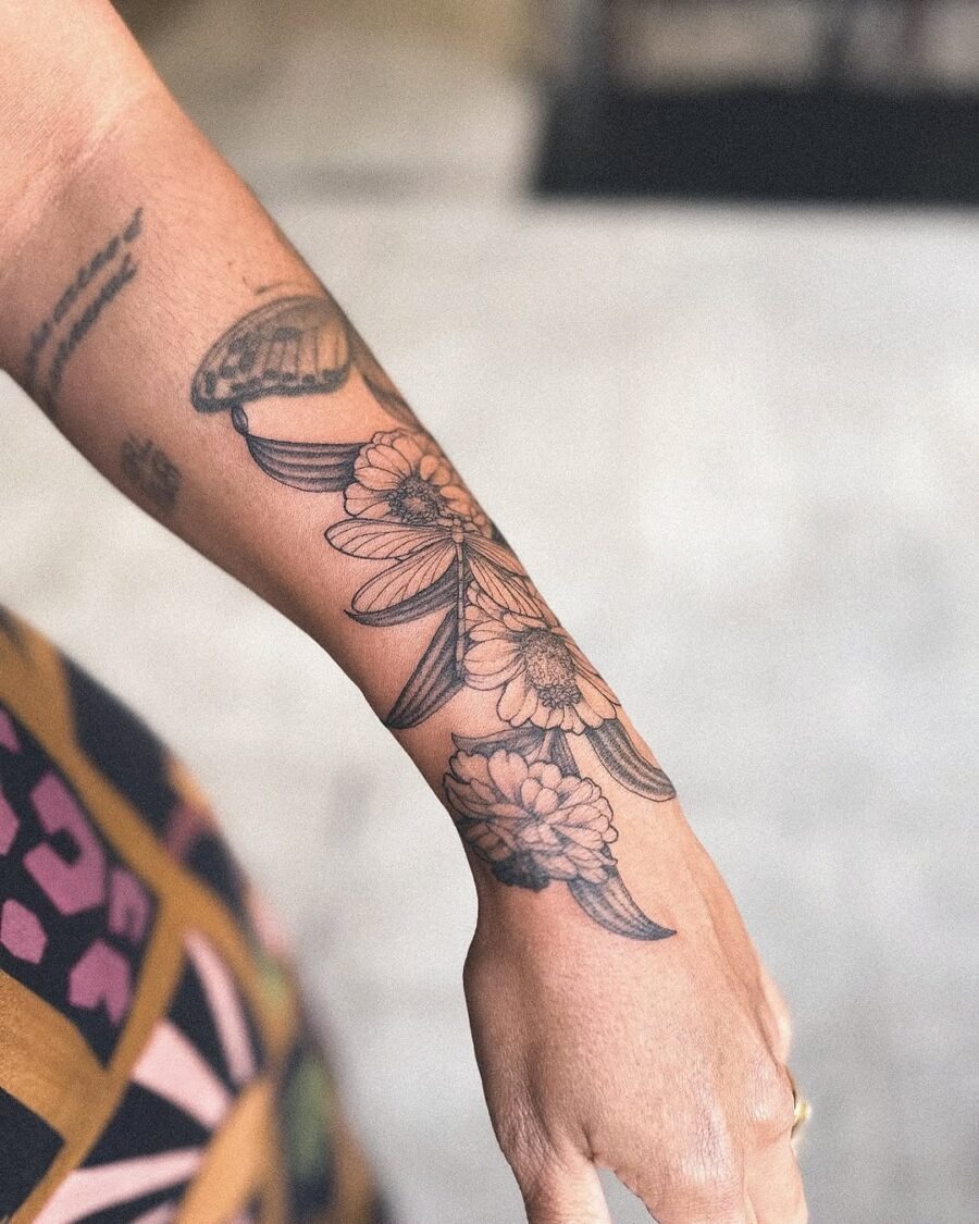 Elegant zinnia tattoo in black ink tones Tattoo Design