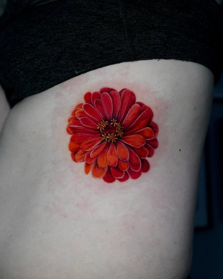 Striking red zinnia tattoo on the side Tattoo Design
