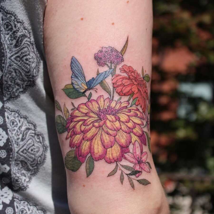 Vibrant Zinnia Tattoo with Butterfly Accents Tattoo Design