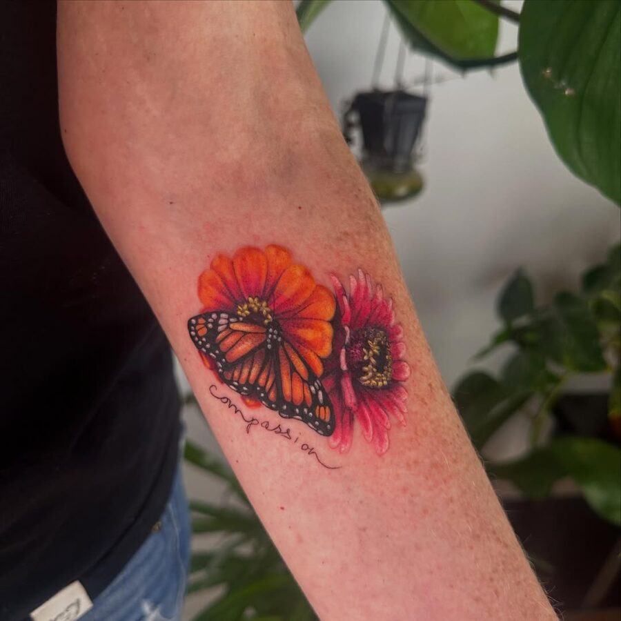 Vibrant zinnia tattoo with butterfly and text Tattoo Design